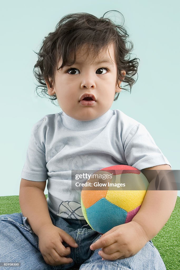 Close-up of a boy holding a ball