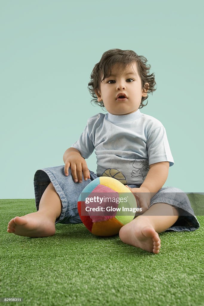 Portrait of a boy playing with a ball