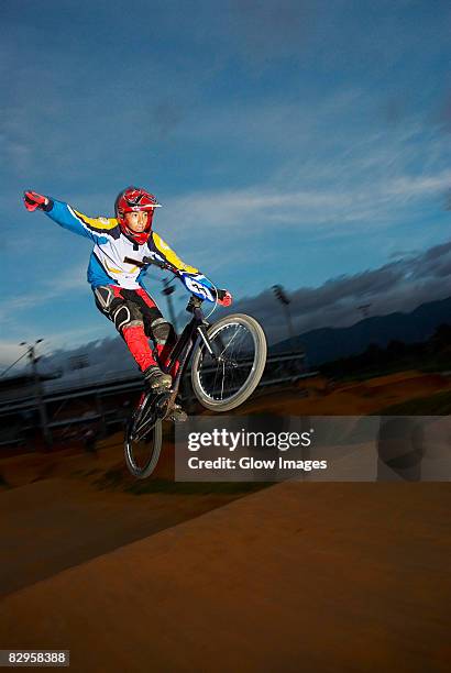 teenage boy performing a stunt on a bicycle - stunt performer bildbanksfoton och bilder