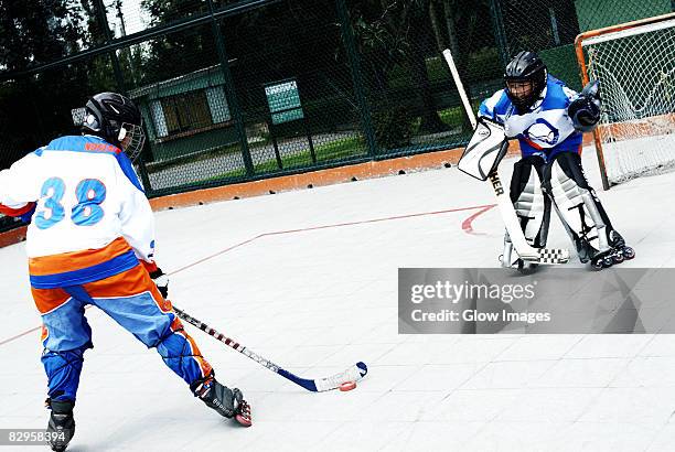 two boys playing ice hockey - ice hockey player back turned stock pictures, royalty-free photos & images