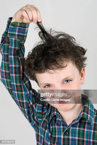 close-up of a boy pulling his hair - child pulling hair stock pictures, royalty-free photos & images