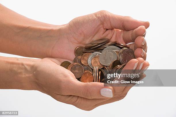 coins in a person's hands cupped - us coin stock pictures, royalty-free photos & images