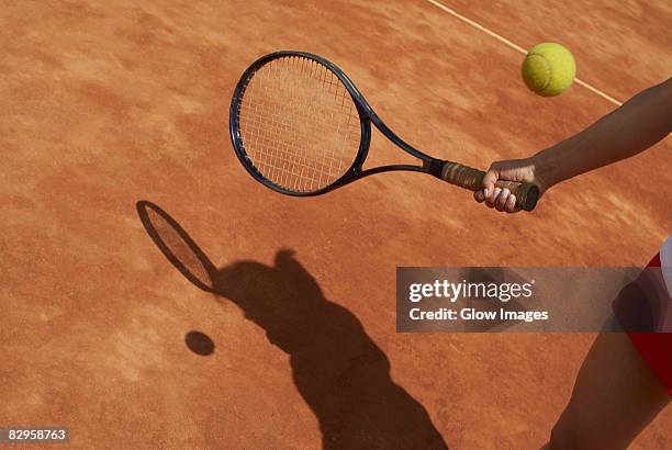mid section view of a female tennis player playing - tennis raquet stock pictures, royalty-free photos & images