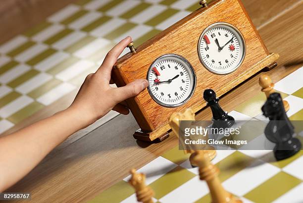 close-up of a human hand pushing button of a chess clock - chess timer stock pictures, royalty-free photos & images