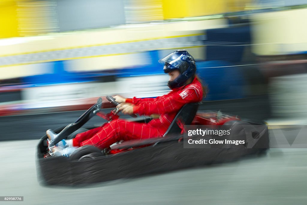 Side profile of a person go-carting on a motor racing track