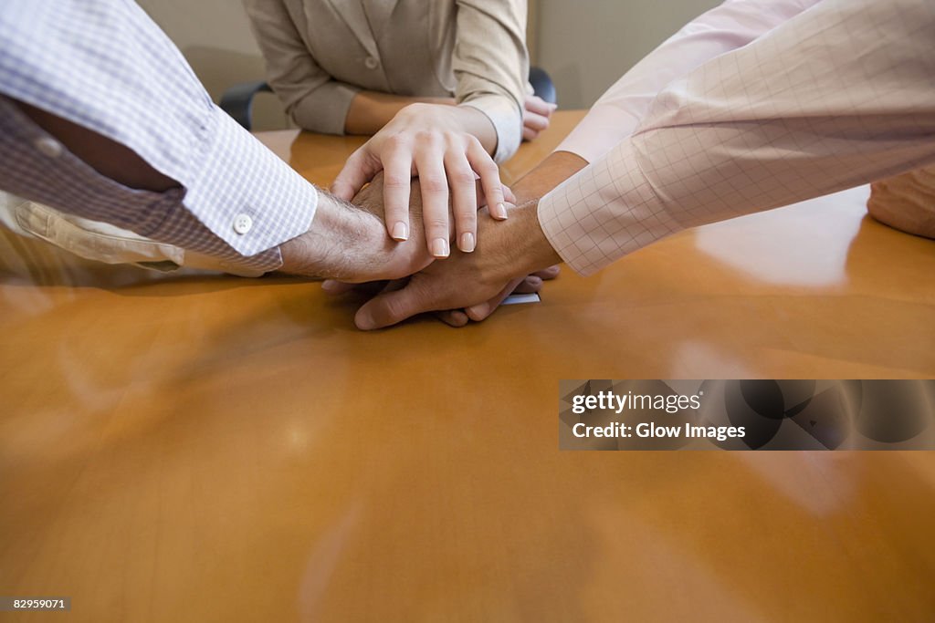 Close-up of five hands stacked on top of each other