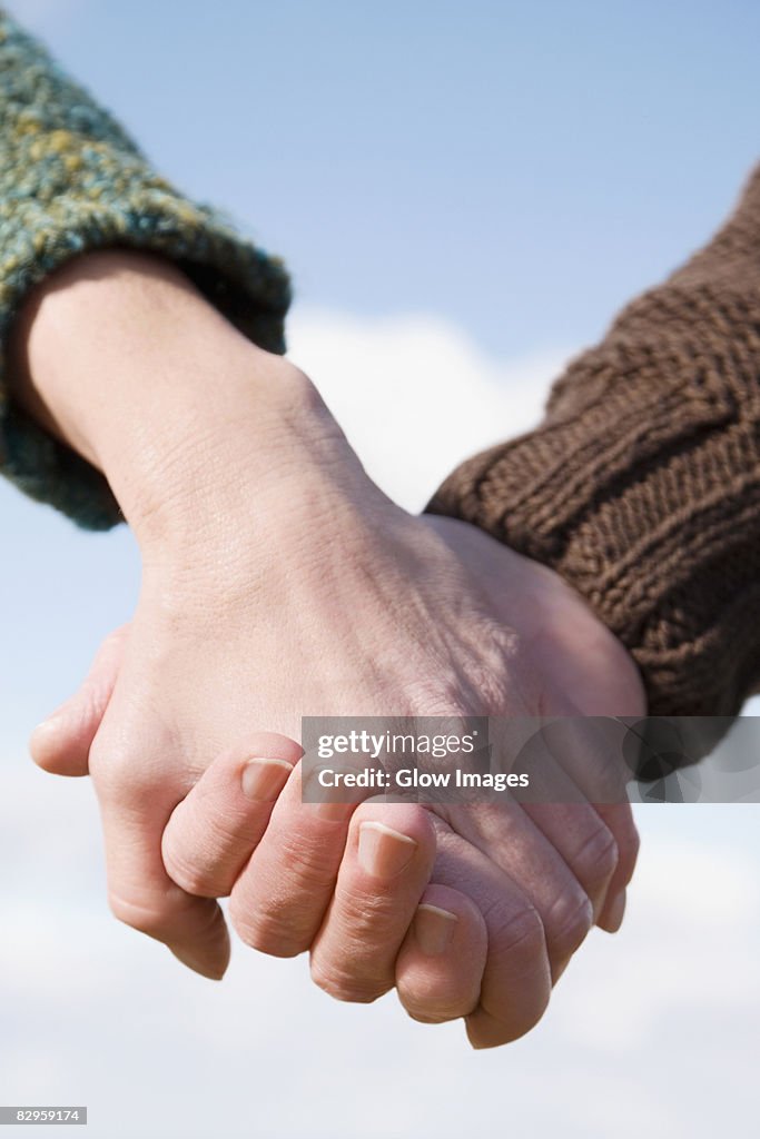 Couple holding each other's hands