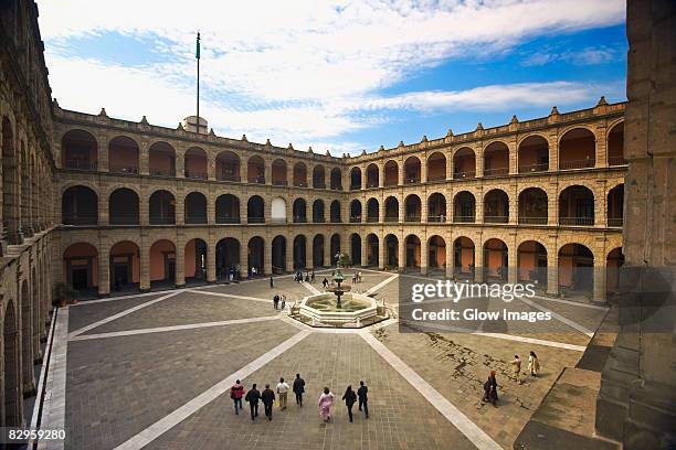 high angle view of tourists in the courtyard of a palace, national palace, zocalo, mexico city, mexico - zocalo mexico city stock pictures, royalty-free photos & images