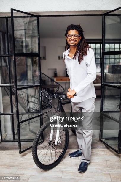 african male entrepreneur with his bicycle - cool house stock pictures, royalty-free photos & images