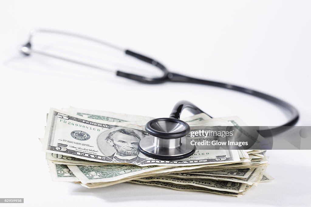 Close-up of stethoscope on US dollar bills