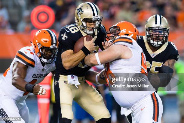 Nate Orchard and defensive end Jamie Meder of the Cleveland Browns of sack quarterback Garrett Grayson of the New Orleans Saints during the first...