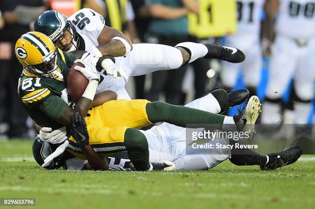 Geronimo Allison of the Green Bay Packers is brought down by Mychal Kendricks of the Philadelphia Eagles during the second quarter of a preseason...