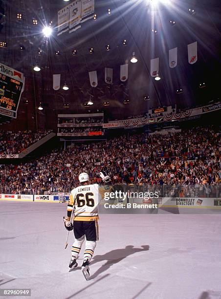 Canadian professional ice hockey player Mario Lemieux of the Pittsburgh Penguins waves to the crowd during the Stanley Cup Finals in a game against...