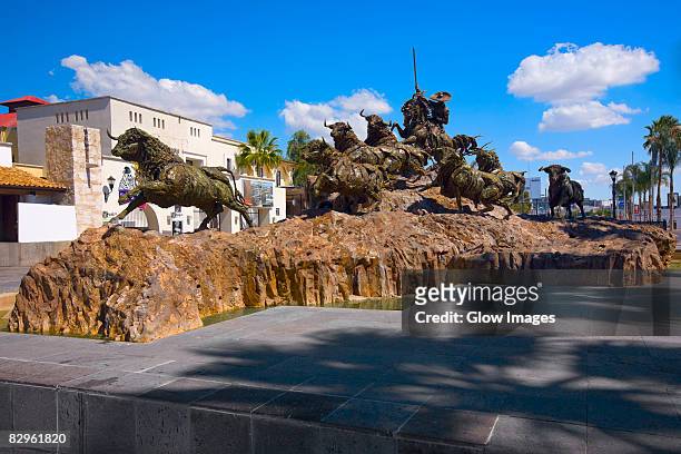 bull statues at a monument, monumento al encierro. aguascalientes, mexico - aguas calientes stock pictures, royalty-free photos & images