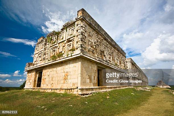low angle view of old ruins of a palace, palacio del gobernador, uxmal, yucatan, mexico - gobernador foto e immagini stock