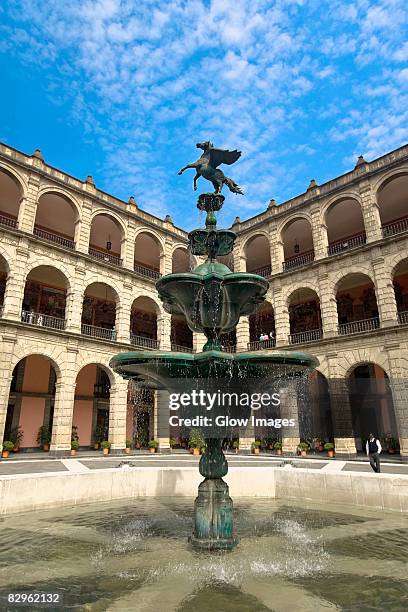 low angle view of a fountain in the courtyard of a government building, national palace, zocalo, mexico city, mexico - palacio nacional foto e immagini stock