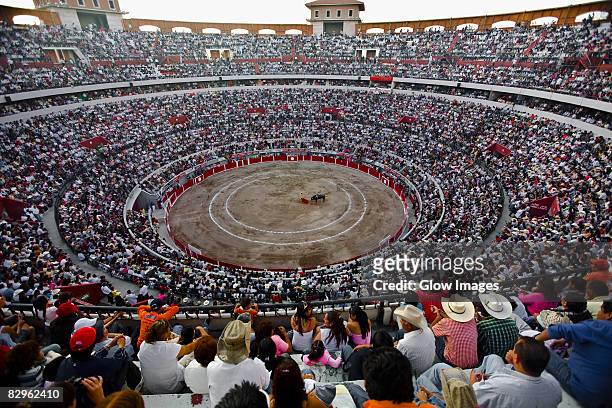 spectators watching a bullfight in a bullring, plaza de toros san marcos, aguascalientes, mexico - bullfighter stock-fotos und bilder
