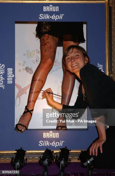 Heidi Klum, the face and legs of Braun, having her legs transformed - the illustration on her legs painted by artist, and sister of actor Jude,...