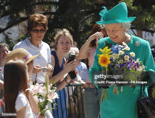 Britain's Queen Elizabeth II greets the crowds after leaving Government House in Regina, Saskatchewan.