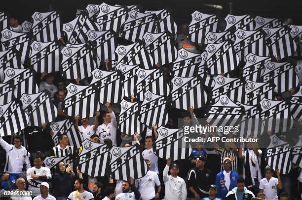 Supporters of Brazilian Santos cheer their team during the 2017 Copa Libertadores football match against Brazil's Atletico Paranaense held at Vila...