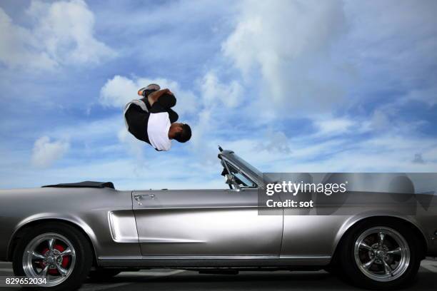 parkour performer to vault over a car - parkour car stock pictures, royalty-free photos & images