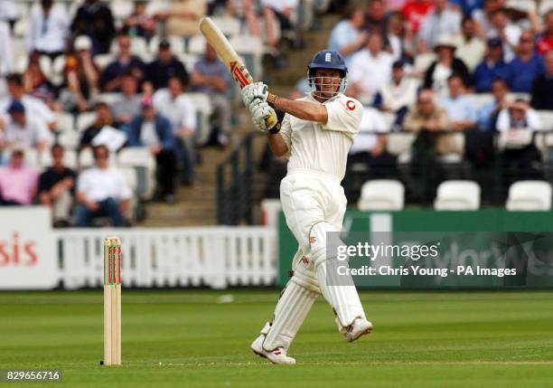 England's Andrew Strauss hits a boundary to reach his half century against Bangladesh.