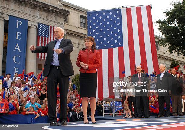 Republican presidential candidate John McCain and vice presidential candidate Gov. Sarah Palin of Alaska appears onstage during a rally outside the...