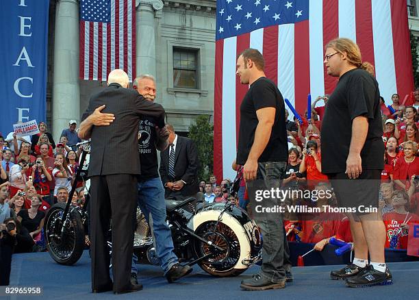 Orange County Choppers Paul Teutel Sr. Hugs Republican presidential candidate John McCain as his sons Paul Teutel Jr. And Mike Teutel look on after...
