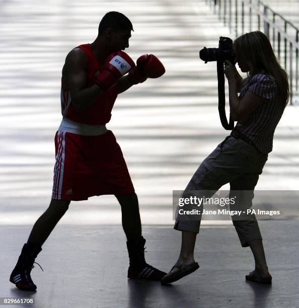 Artist Sam Taylor-Wood, left, takes a photograph of boxer Amir Khan to launch a new Tate online initiative to showcase British artistic talent via...