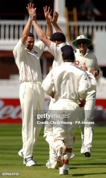 England's Steve Harmison and Andrew Flintoff celebrate Bangladesh's Mashrafee Mortaza's wicket.