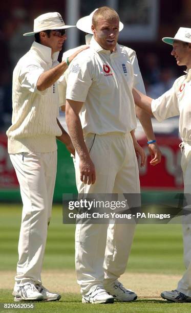 England's Andrew Flintoff receives a pat on the back from captain Michael Vaughan after he dismissed Khaled Mashud to end Bangladesh's second innings...