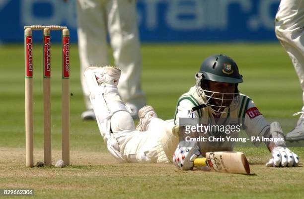 Bangladesh's Khaled Mashud makes a desperate dive as they struggle to stay in.