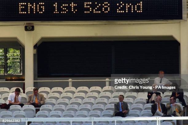 Members sit in a sparsely populated pavilion, as Bangladesh struggle to chase England's first innings total.