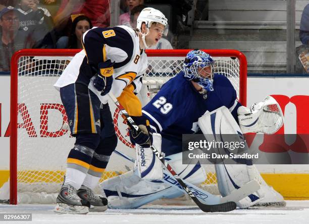 Goaltender Justin Pogge of the Toronto Maple Leafs keeps an eye on the play along with Marek Zagrapan of the Buffalo Sabres during a preseason NHL...