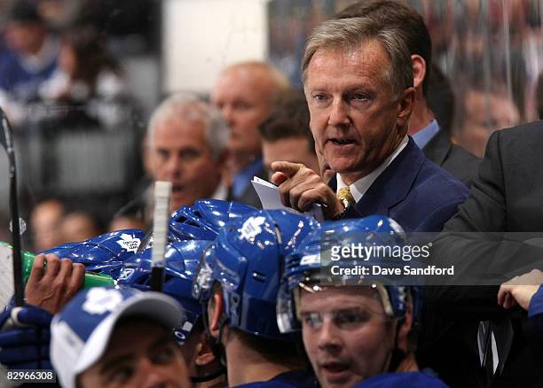 Head coach Ron Wilson of the Toronto Maple Leafs gives instruction behind the bench during action against the Buffalo Sabres during a preseason NHL...