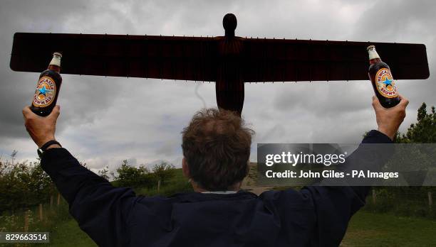 Two bottles of Newcastle Brown Ale are held in front of the Angel of the North, Gateshead as the first batch to be brewed outside of Newcastle came...