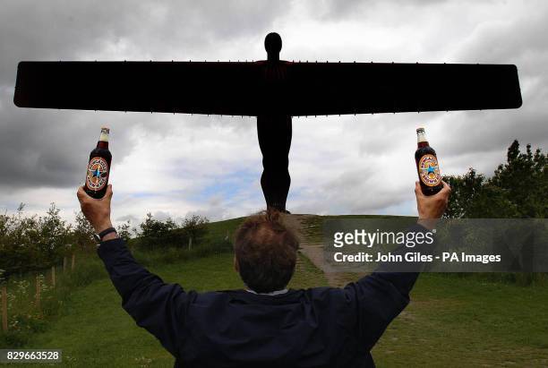 Two bottles of Newcastle Brown Ale are held in front of the Angel of the North, Gateshead as the first batch to be brewed outside of Newcastle came...