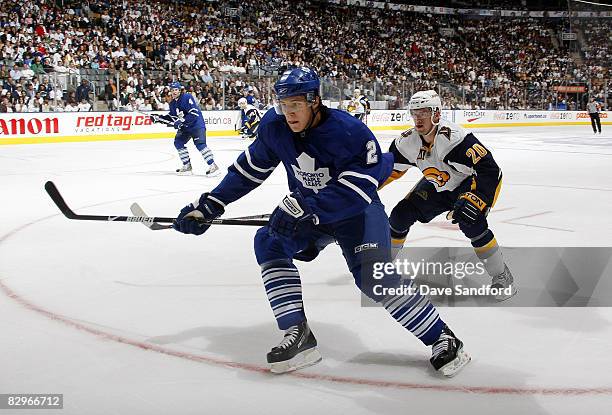 Luke Schenn of the Toronto Maple Leafs skates for the puck defended by Daniel Paille of the Buffalo Sabres during a preseason NHL game at the Air...