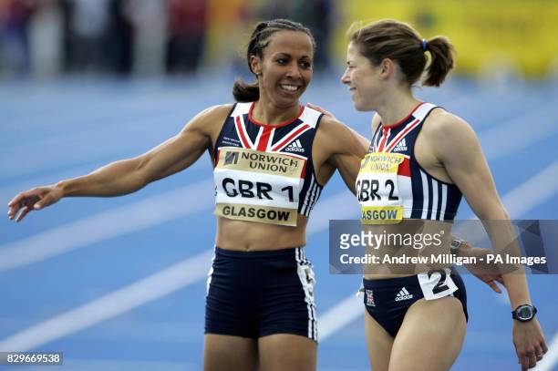 Great Britain's Kelly Holmes who wins the 1500 metres womens race celebrates with team-mate Helen Clitheroe.