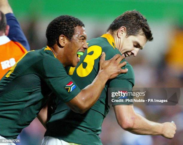 South Africa's Ashwin Willemse congratulates team-mate Jaque Fourie after he scored a try against Uruguay during their Rugby World Cup Pool C match...