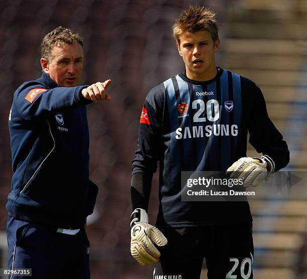 Coach Ernie Merrick gives instructions to Mitchell Langerak of the Victory during a Melbourne Victory A-League training session at Olympic Park on...