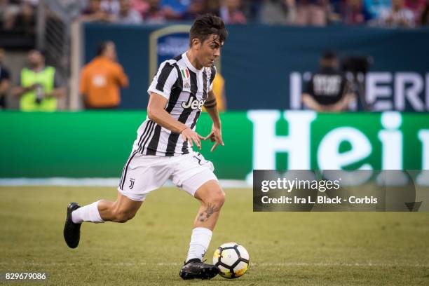 Paulo Dybala of Juventus takes the ball across the pitch during the International Champions Cup match between FC Barcelona and Juventus at the...