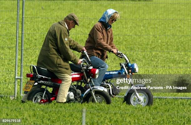 The Duke Of Edinburugh and Lady Penny Romsey on mini motorbikes.