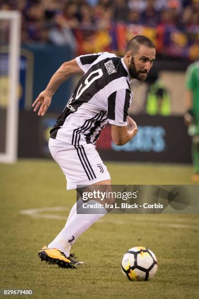 Gonzalo Higuain of Juventus shows his determination to get to the goal during the International Champions Cup match between FC Barcelona and Juventus...