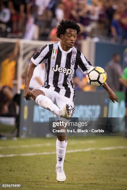 Juan Cuadrado of Juventus kicks the ball to keep control during the International Champions Cup match between FC Barcelona and Juventus at the...
