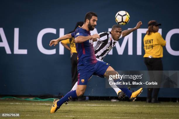 Douglas Costa of Juventus heads the ball against Jordi Alba of Barcelona during the International Champions Cup match between FC Barcelona and...