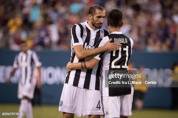 Captain Giorgio Chiellini of Juventus hugs Paulo Dybala of Juventus after the International Champions Cup match between FC Barcelona and Juventus at...