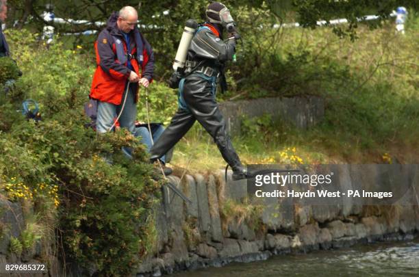 Police diver enters Victoria Dock, where PSNI are preserving the scene where a mans body was discovered in a car dumped in the Newry Canal,...