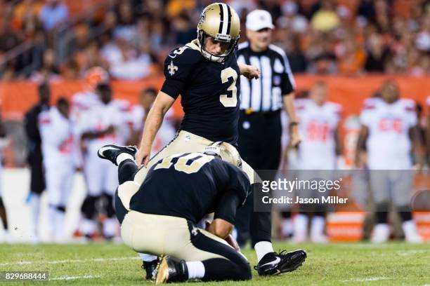 Chase Daniel holds for kicker Wil Lutz of the New Orleans Saints during the first half of a preseason game against the Cleveland Browns at...