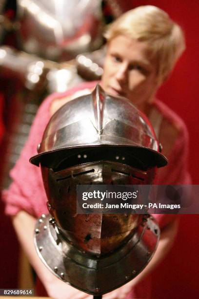 Visitor to the Grosvenor House Art & Antiques Fair in central London, Monday 13 June 2005, studies a German helmet dating back to circa 1620 and once...